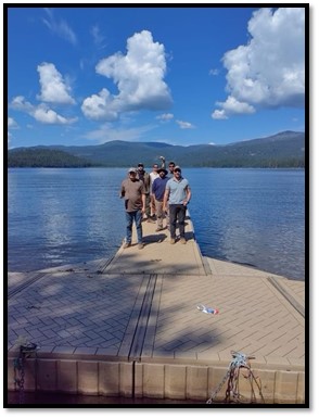 Group photograph on a mountain lake dock.
